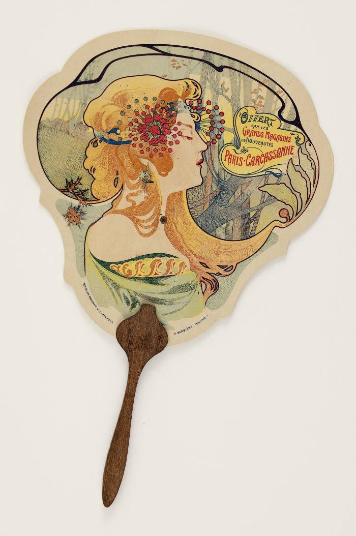Lithographic Promotional Fan. On recto orange haired woman with red flower and green background. On verso various text including "Grands Magasins de Nouveautes"